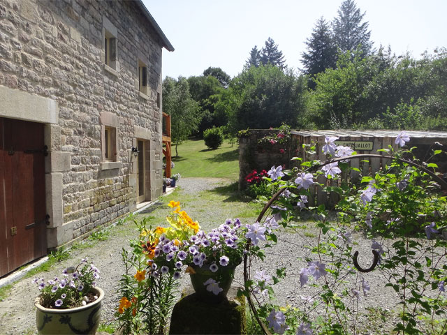 Garden exterior in French stately home with flowers and stone walls