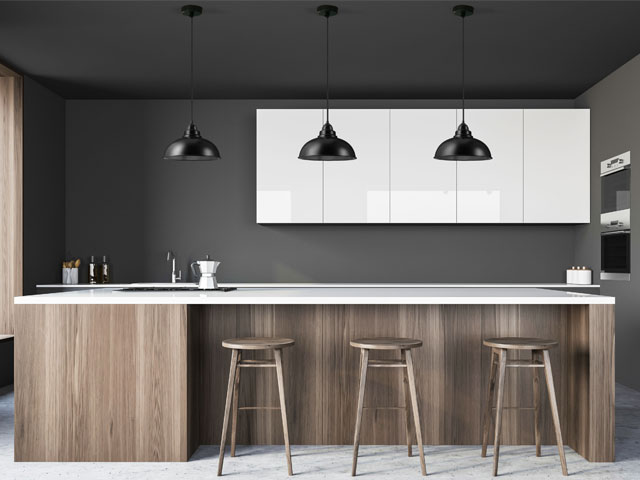 modern kitchen with dark grey walls, white cupboards and matt black pendant lights