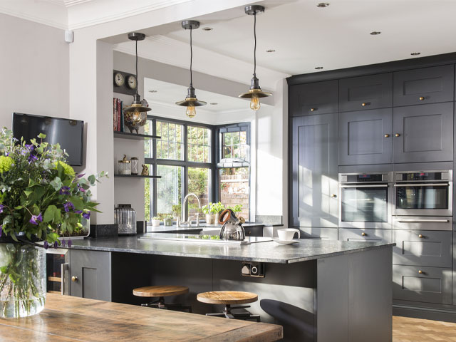 exposed bulb pendant lights in an open-plan kitchen diner