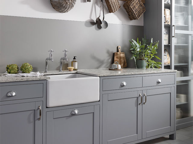 Grey cabinet utility room with basin sink and traditional taps with grey splashback