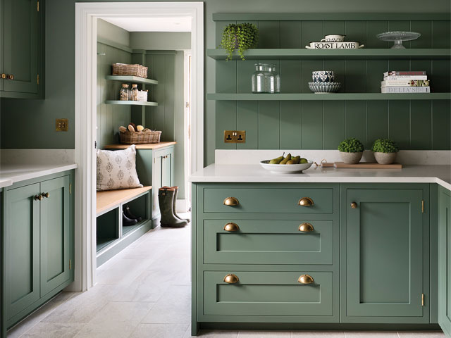 light green utility room with gold fixtures and white surfaces