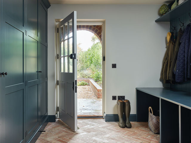 house side entrance with storage and herringbone flooring blue cabinets