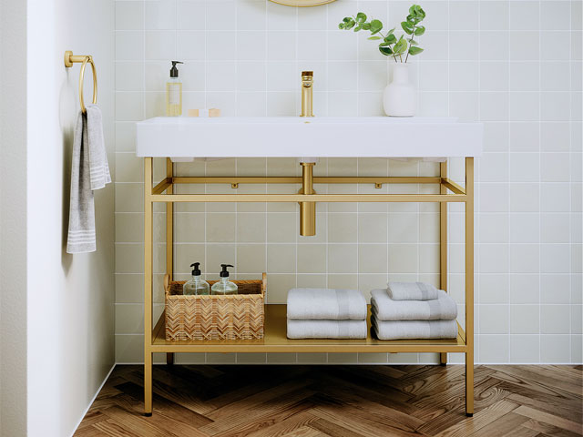 white basin on gold frame stand with hand towel rail and herringbone wood flooring