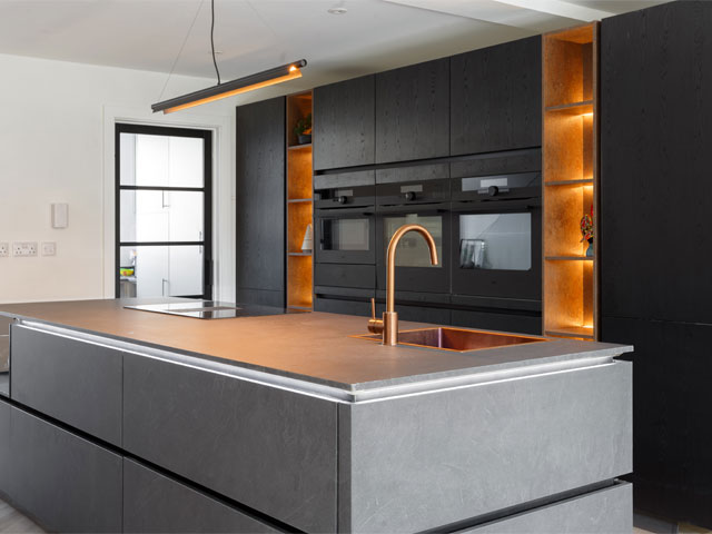 modern kitchen with gold tap and backlit amber shelving crittall window