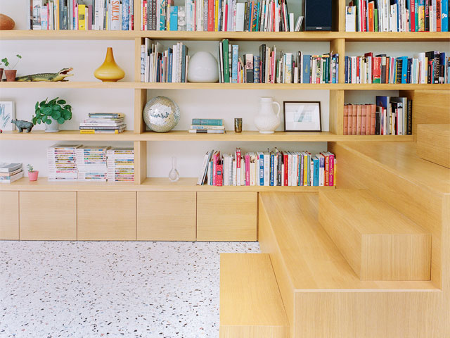 staircase bookshelf close up with white terrazzo flooring