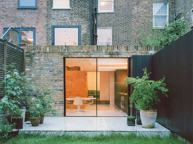 Brick extension exterior potted plants white patio 