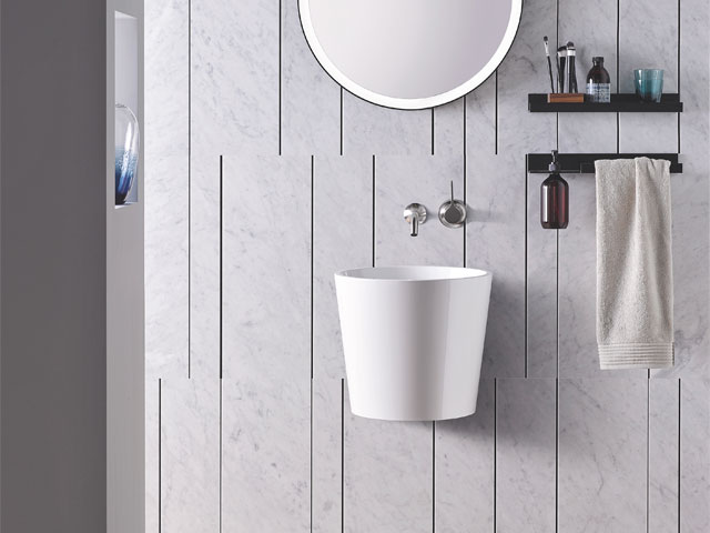long white wall hung basin with silver taps and circular mirror 