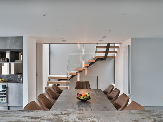 Contemporary kitchen on Grand Designs: The Streets large staircase pendant lighting large dining table fruit bowl