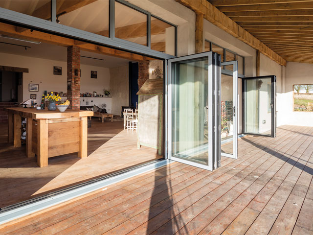 timber decking full length patio doors opened wooden kitchen island open plan area