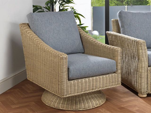 swivel chairs. Wicker furniture with grey seat covers on herringbone flooring