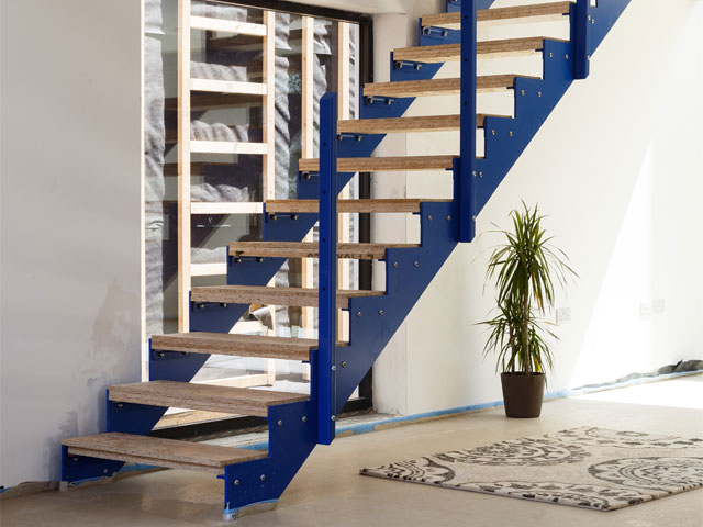 blue coloured steel stairs wooden rungs wood flooring small houseplant