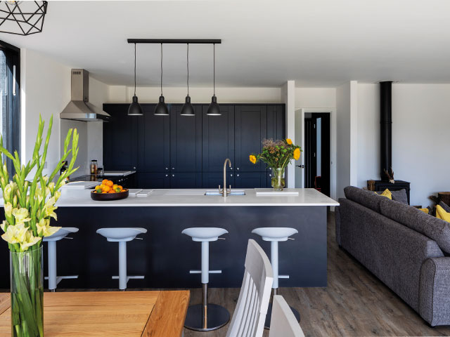 blue grey contemporary kitchen white barstools black hanging lights