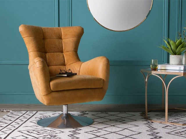 swivel chairs with metal base on white patter rug teal painted wall gold framed mirror