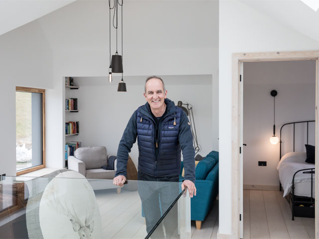 Kevin McCloud Iron framed bed blue sofa bookcase industrial pendant lighting glass balustrade