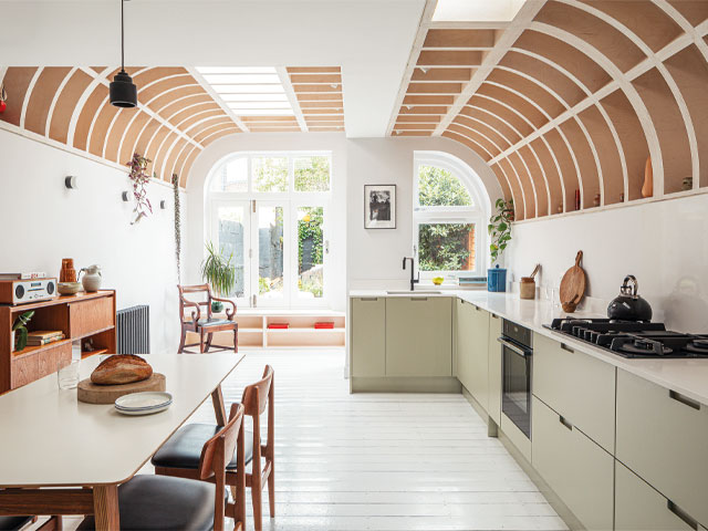 Renovate for less. open plan kitchen curved timber roof light green kitchen cabinets 