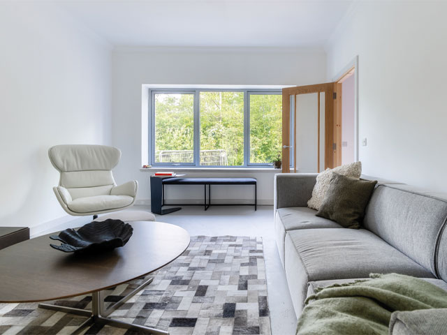 Grand Designs: The Streets long grey sofa oval wooden table geometric grey rug