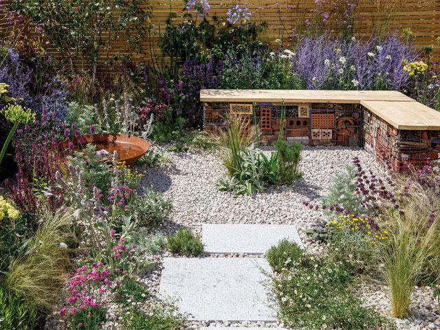 gravel and wildflower garden stone slabs wooden bench cage bricks 