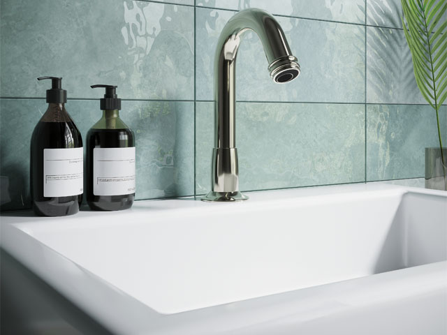 vintage bathroom. White sink light teal tiles single silver faucet dark bottle hand lotion 