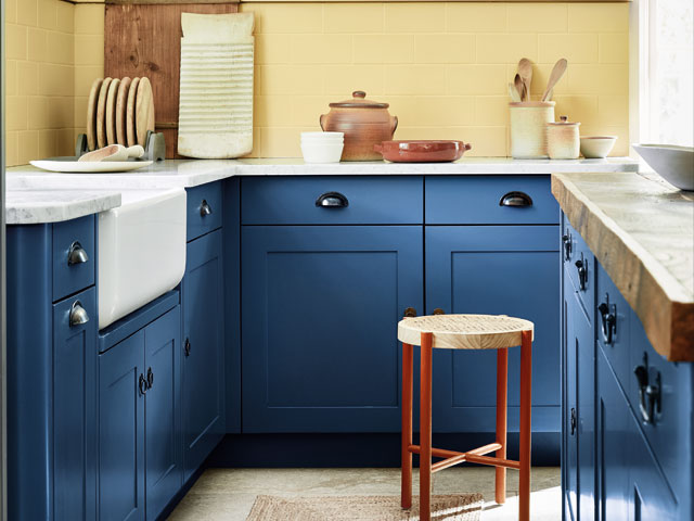 kitchen renovation blue kitchen cabinets steel handles yellow backsplash