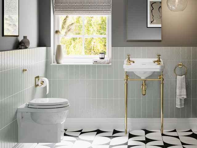 pale green tiles wall hung toilet gold taps gold fixtures grey painted wall
