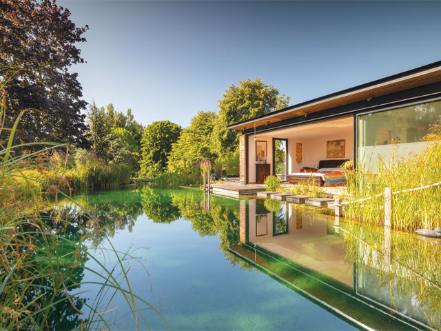 swimming ponds with reeds large glazed windows bed in the woods