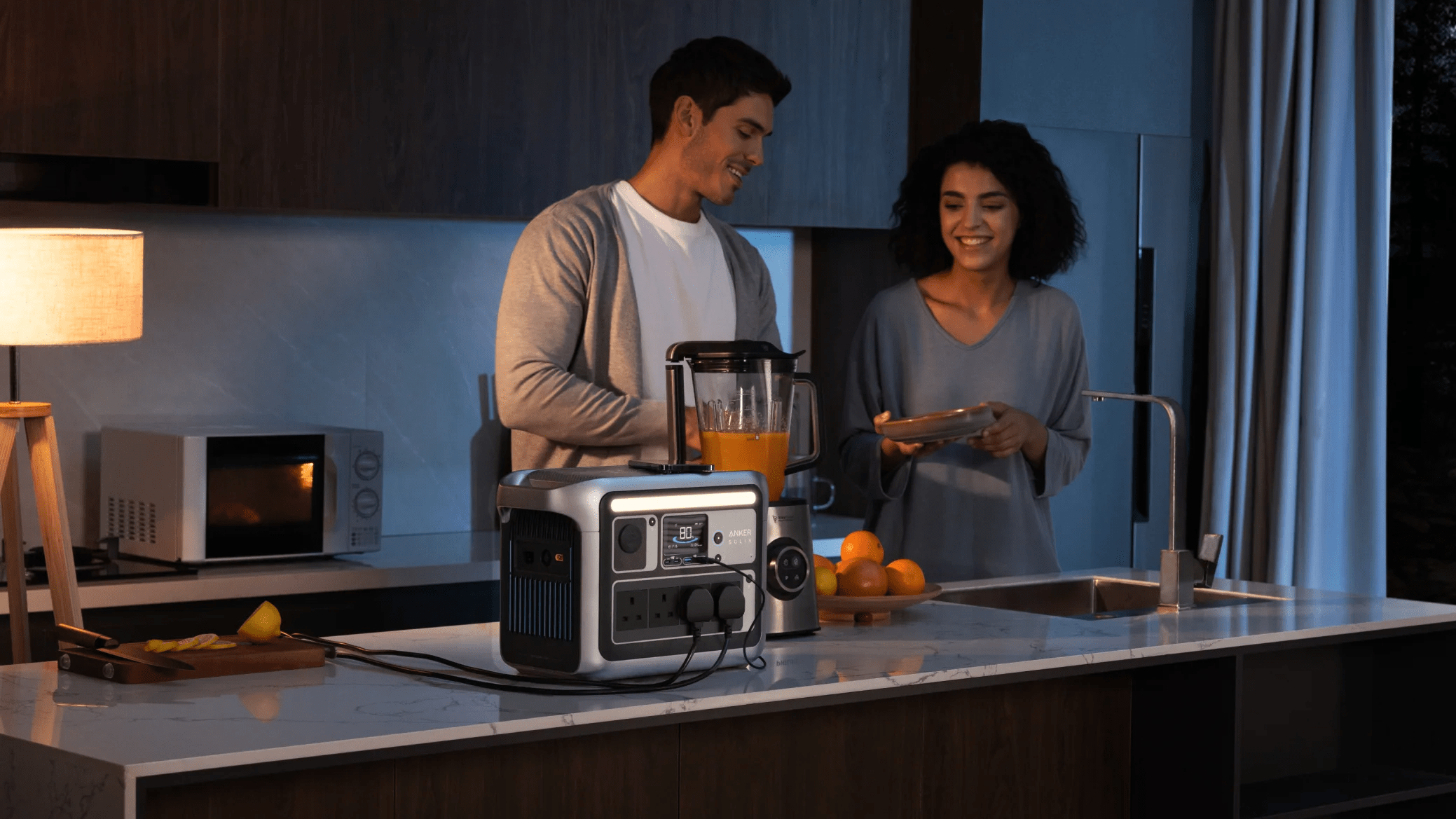 A couple power a blender, mobile device and other kitchen appliances from an Anker SOLIX C1000 portable power station
