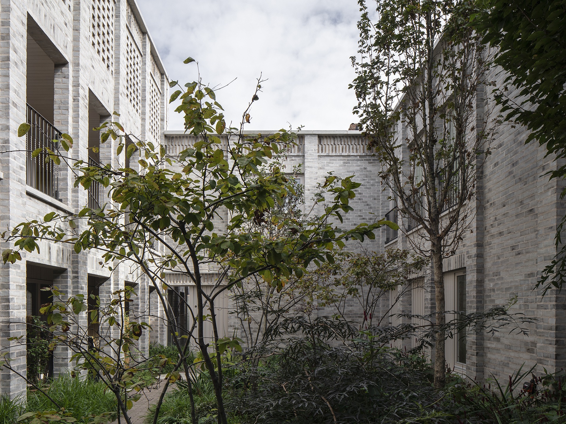 A housing complex built round a courtyard with trees i n it