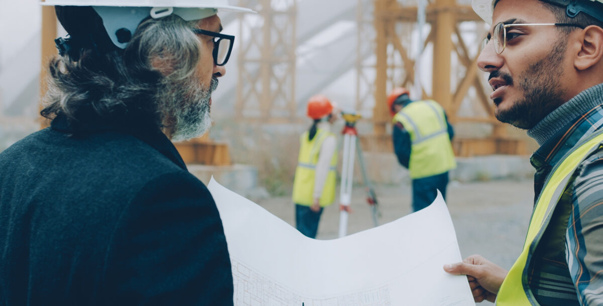 Two surveyors on a building site