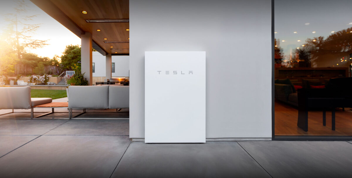 A Tesla powerwall fixed to an outside wall
