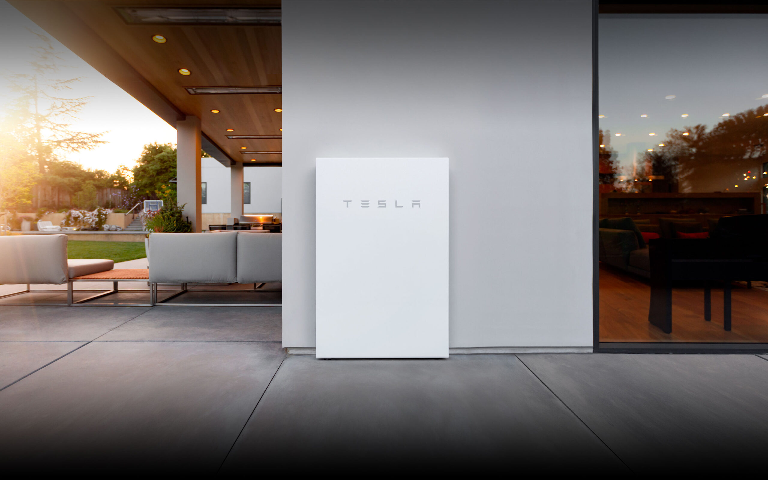 A Tesla powerwall fixed to an outside wall