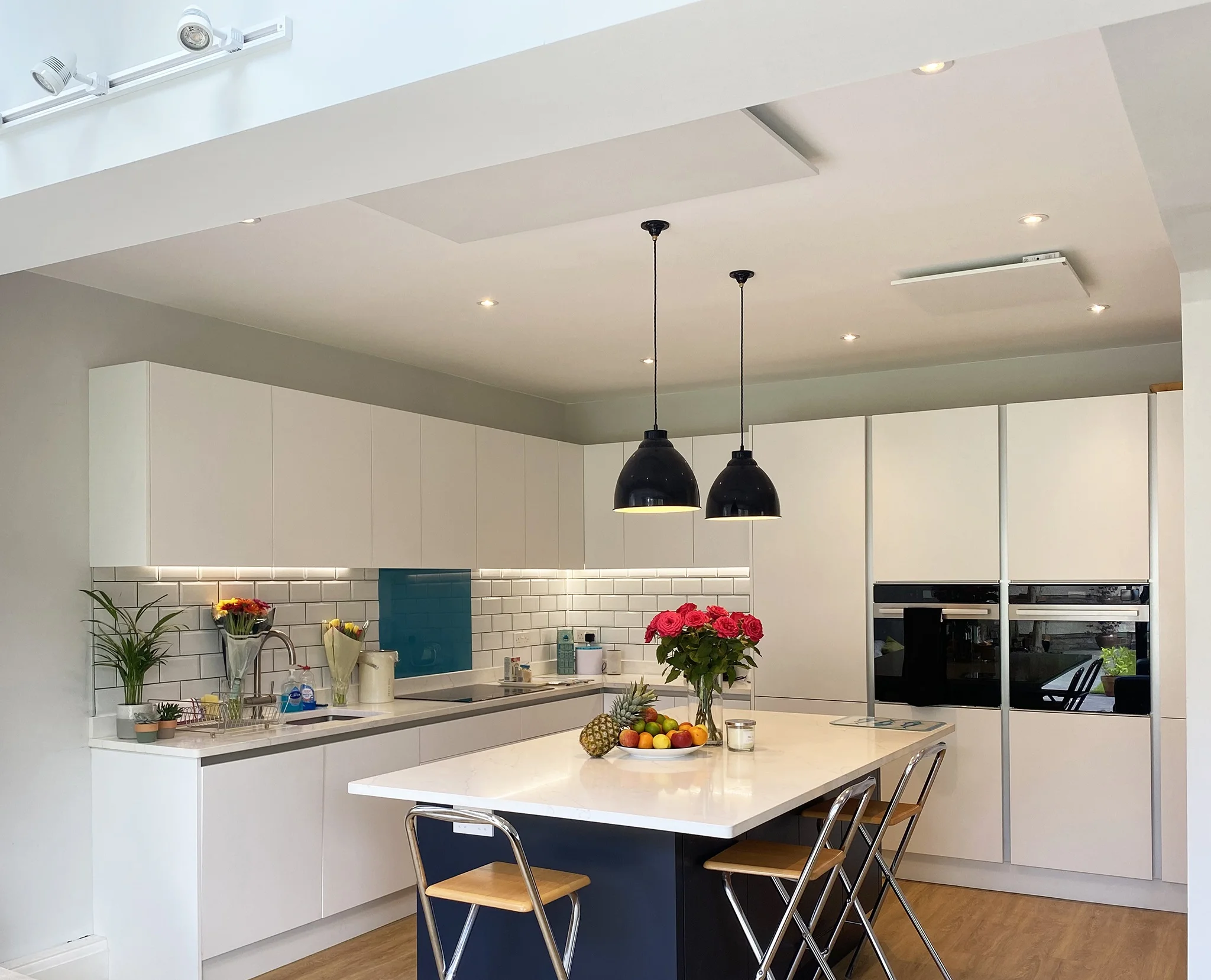 A kitchen fitted with two thin infrared ceiling panels
