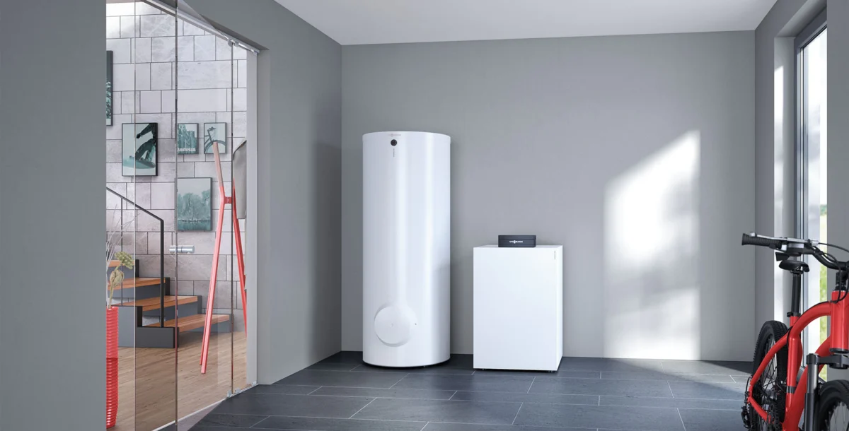 A ground-source heat pump and water cylinder in a utility room