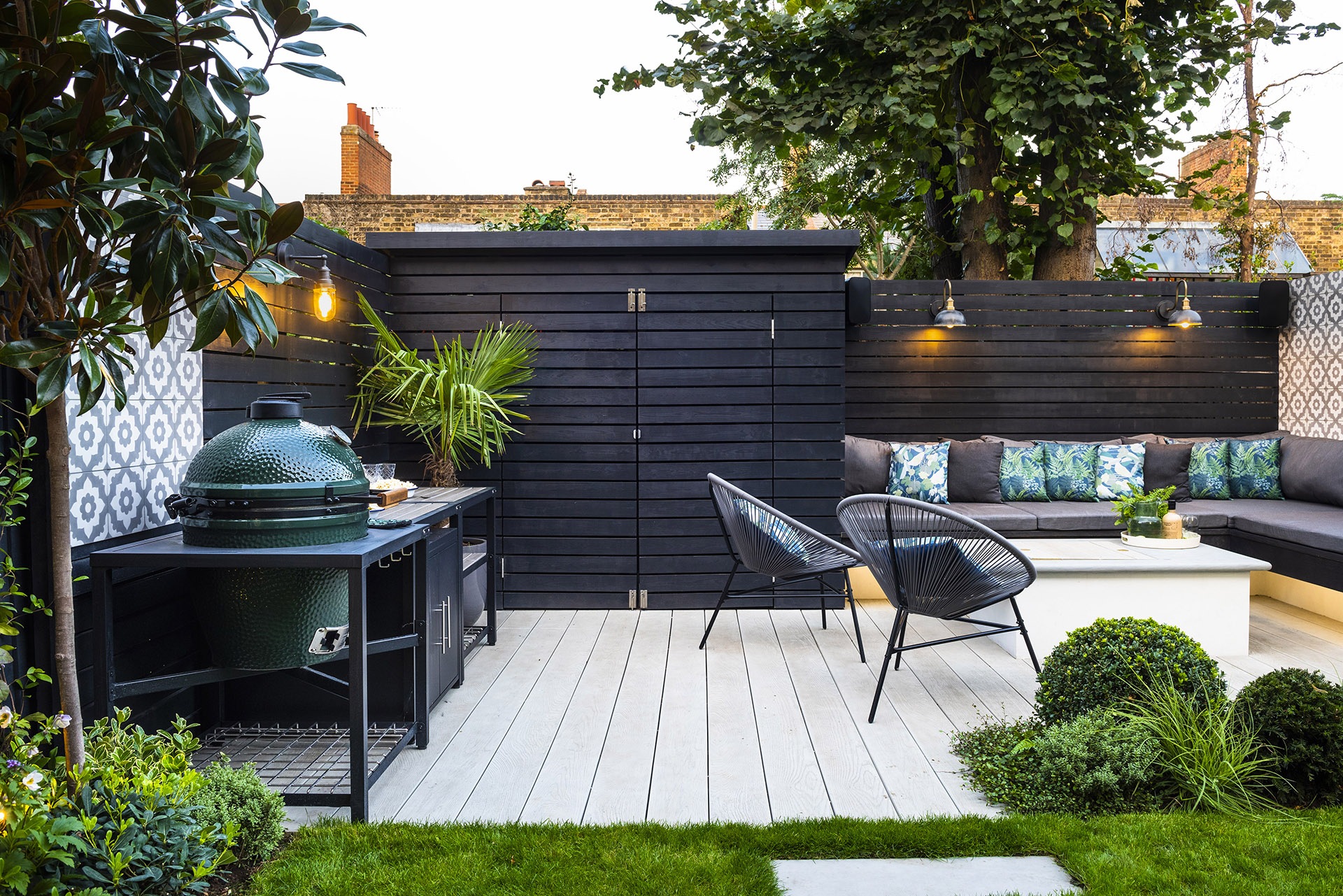 An outdoor kitchen with BBQ inset in furniture