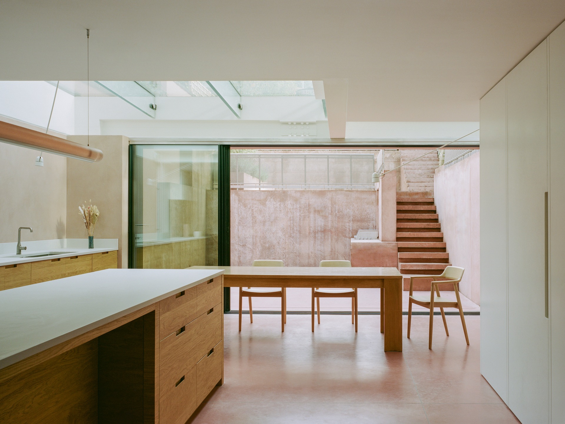 Designed by practice Unknown Works (unknown.works), this open-plan ground-floor kitchen and living area spans the entire footprint of a four-bedroom house in Hampstead, north London.