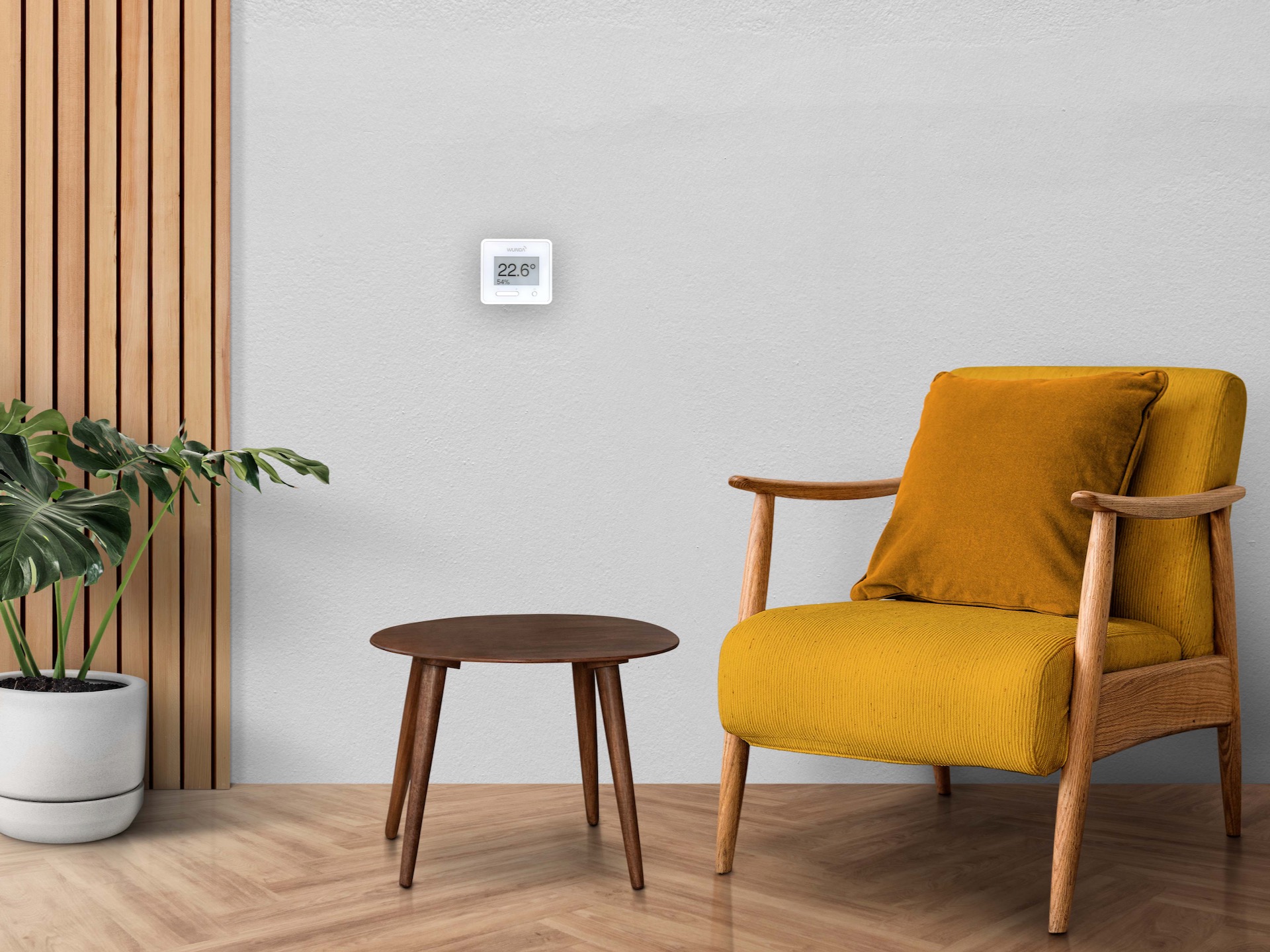 Living room with grey wall, mustard chair and thermostat