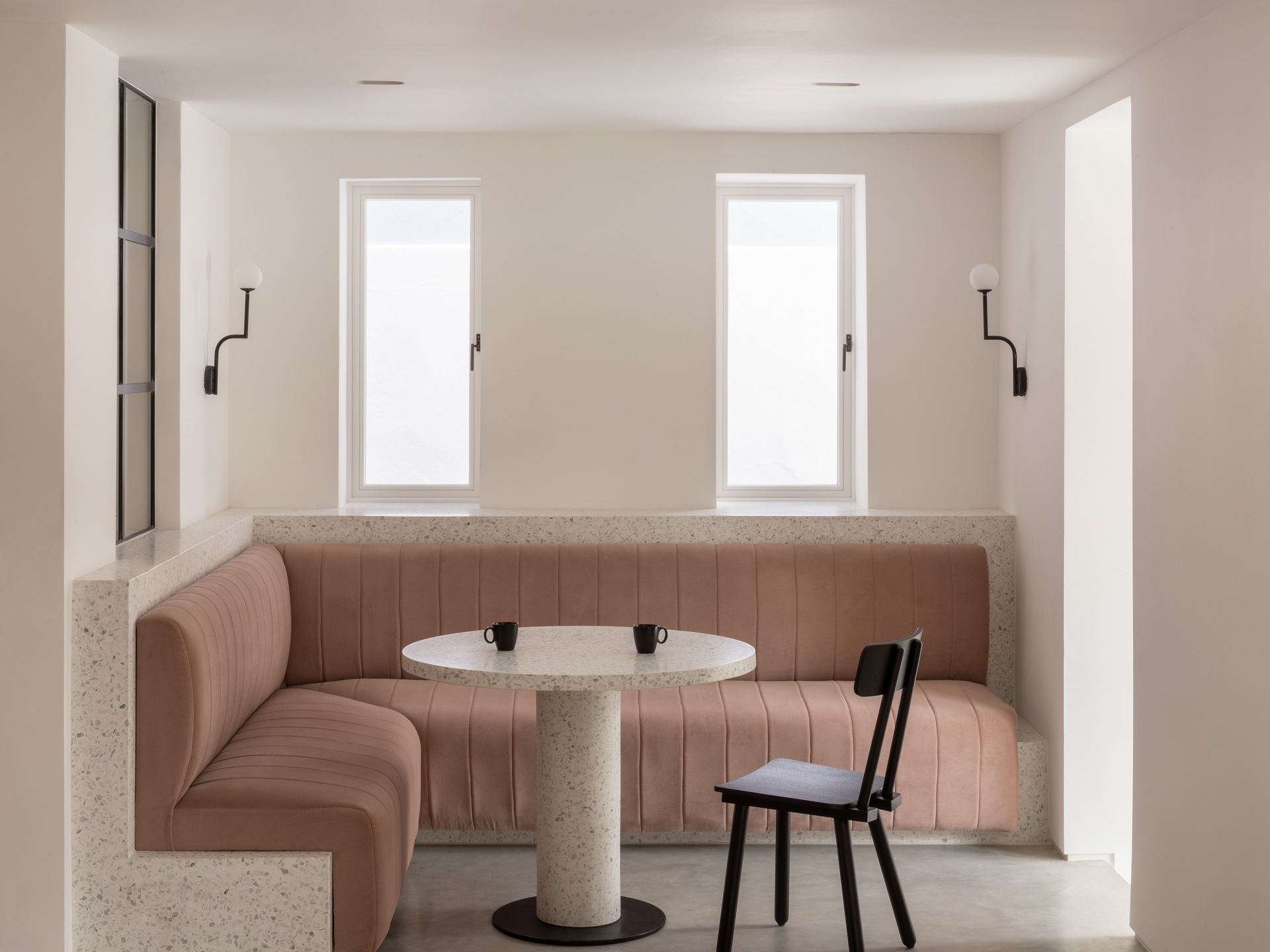 A diner-inspired seating area with pink upholstery