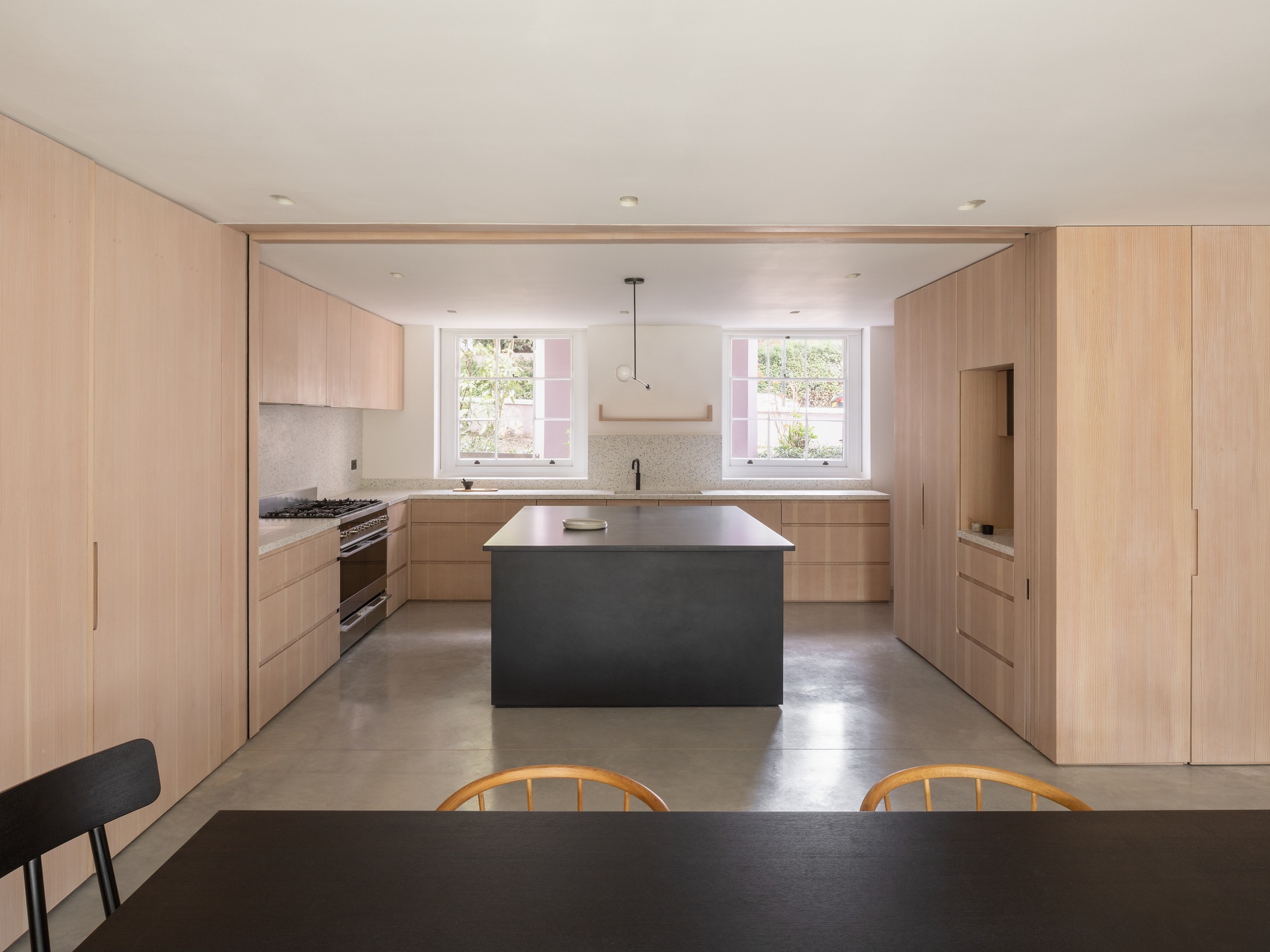 Polished concrete floors run through this modern renovation