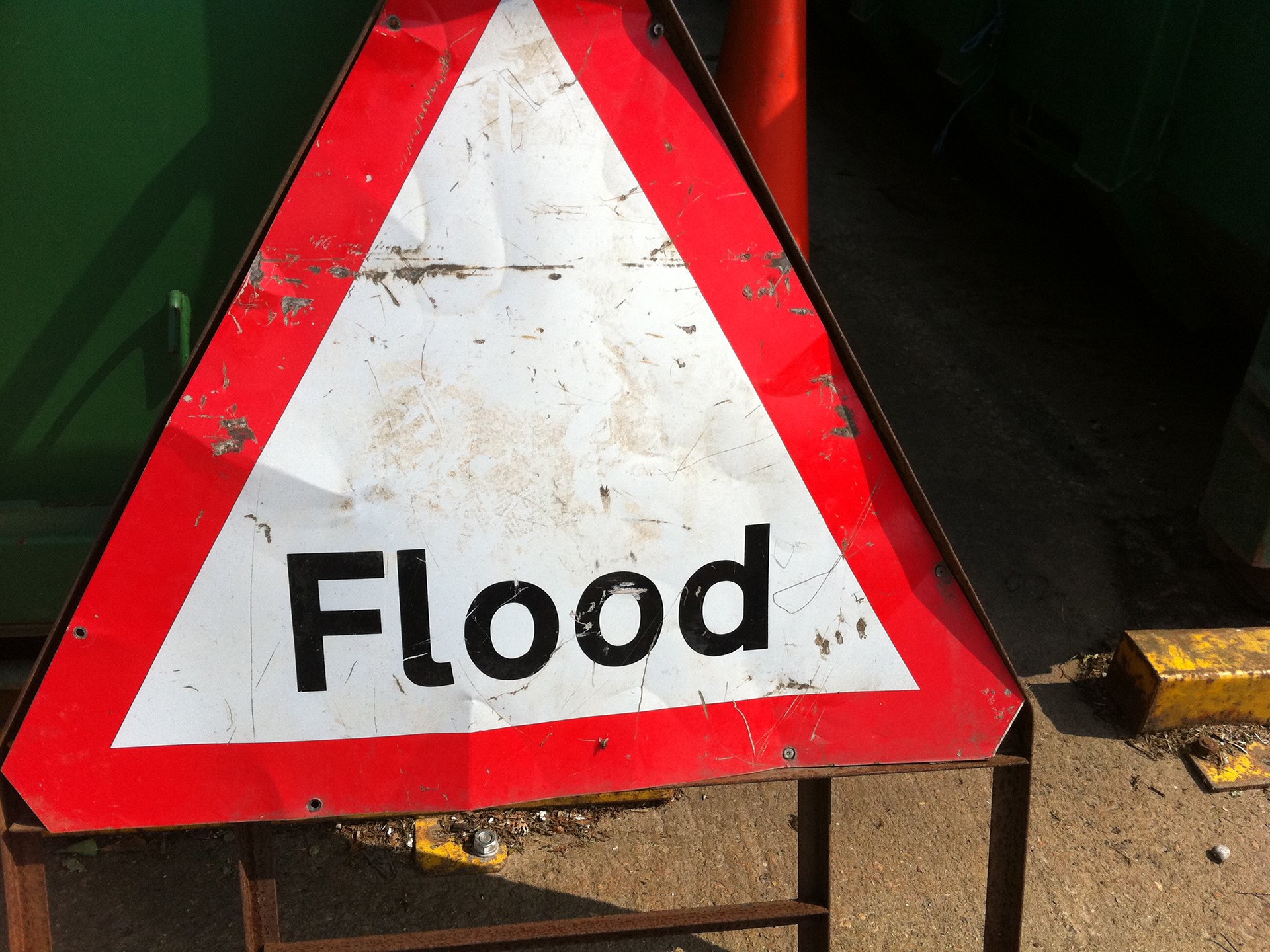 A battered flood sign
