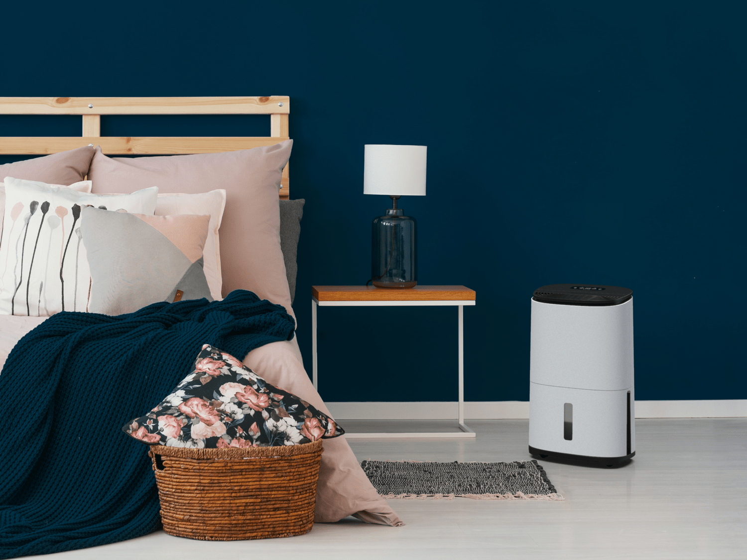A lifestyle photo showing a Meaco Arete dehumidifier in a bedroom setting