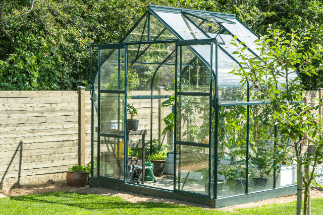 Glass greenhouse in garden