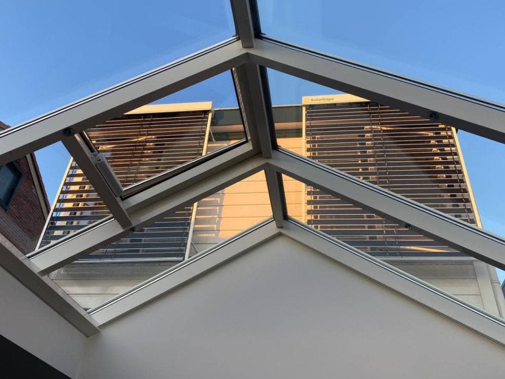 SolarGaps blinds installed outside two windows of a loft apartment in the Netherlands