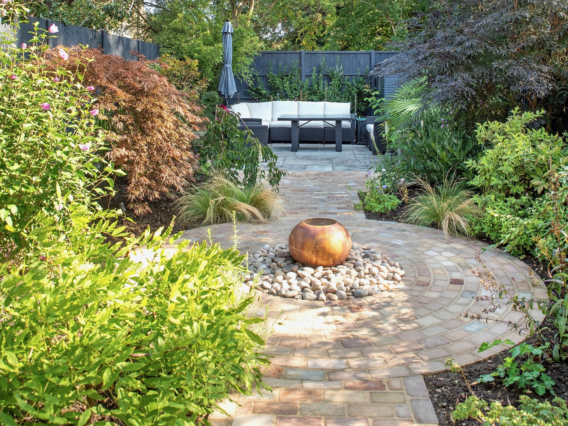 Curved garden path with water feature