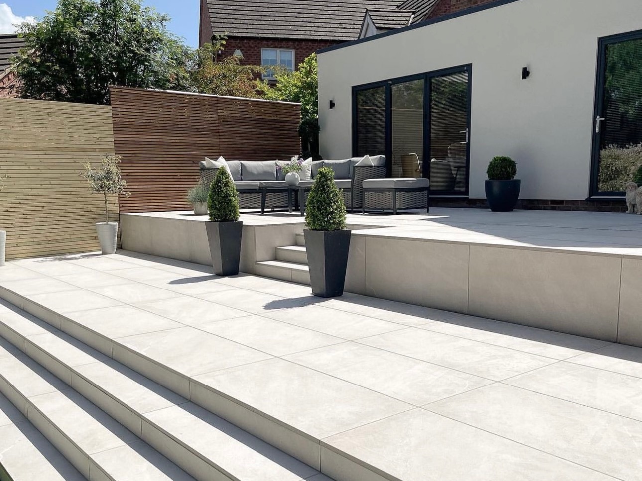 Back garden with porcelain paving steps by RV Paving