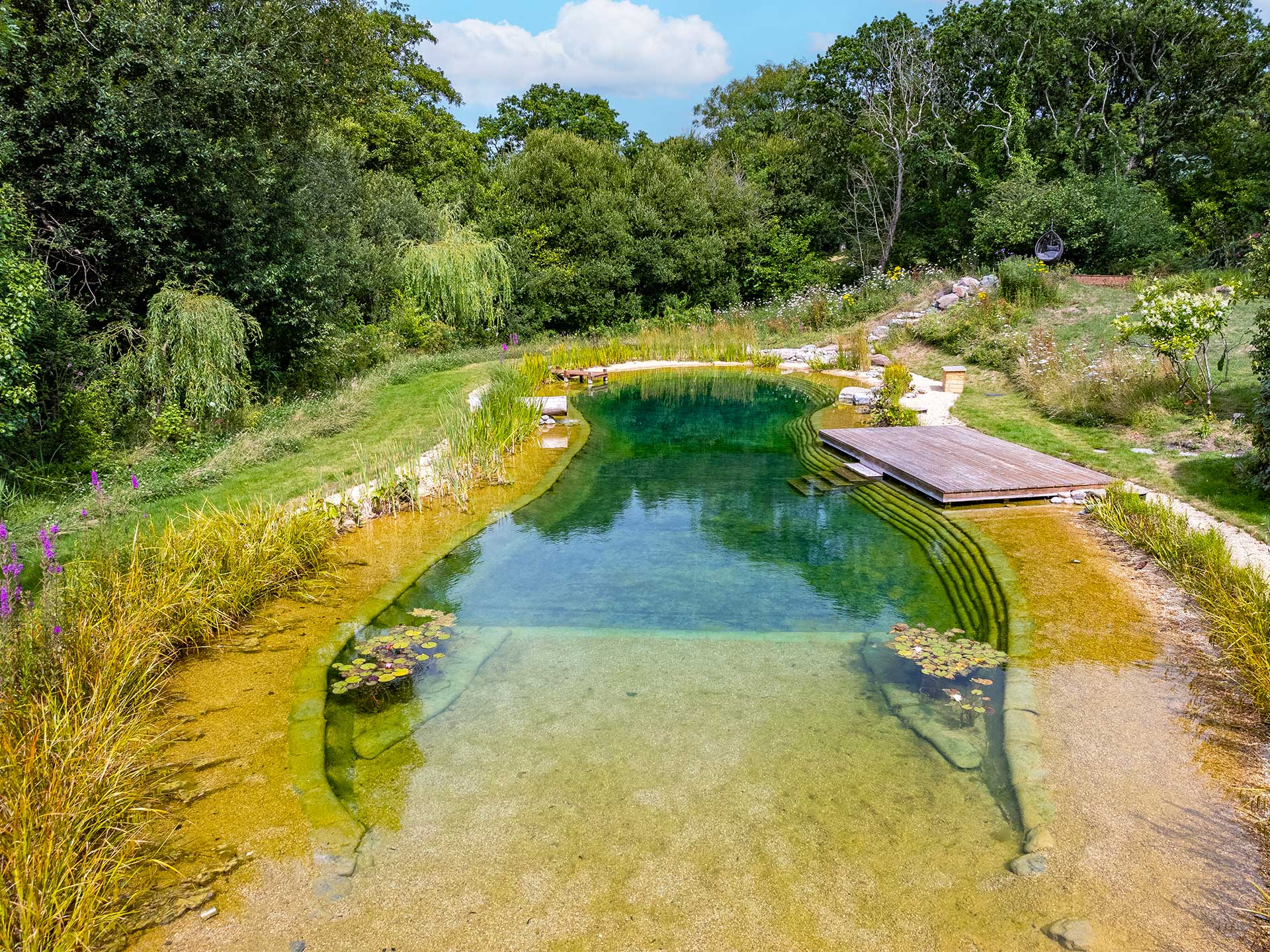 A natural swimming pond featuring crystal-clear waters
