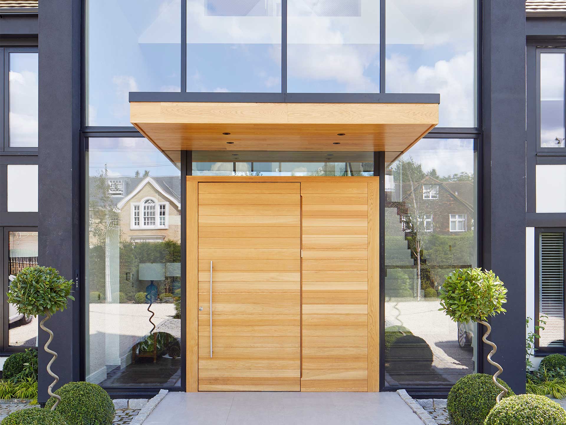 If you don't have the space for a full porch, you could enjoy the benefits of a door canopy.Clear windows with wooden door