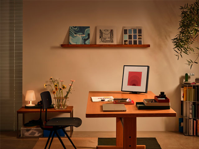Home office with smart speaker that looks like a framed picture on work desk