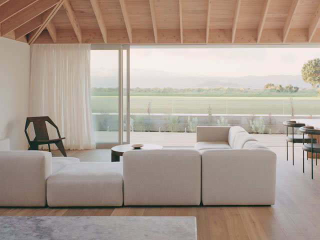 Living room with timber ceiling and big white sofa