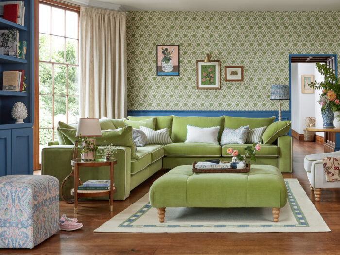 A beautiful living room in an old house with a large green sofa