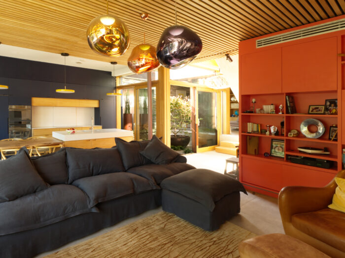 Living room in the Sydenham self-build house with big sofas and sculptural light fittings