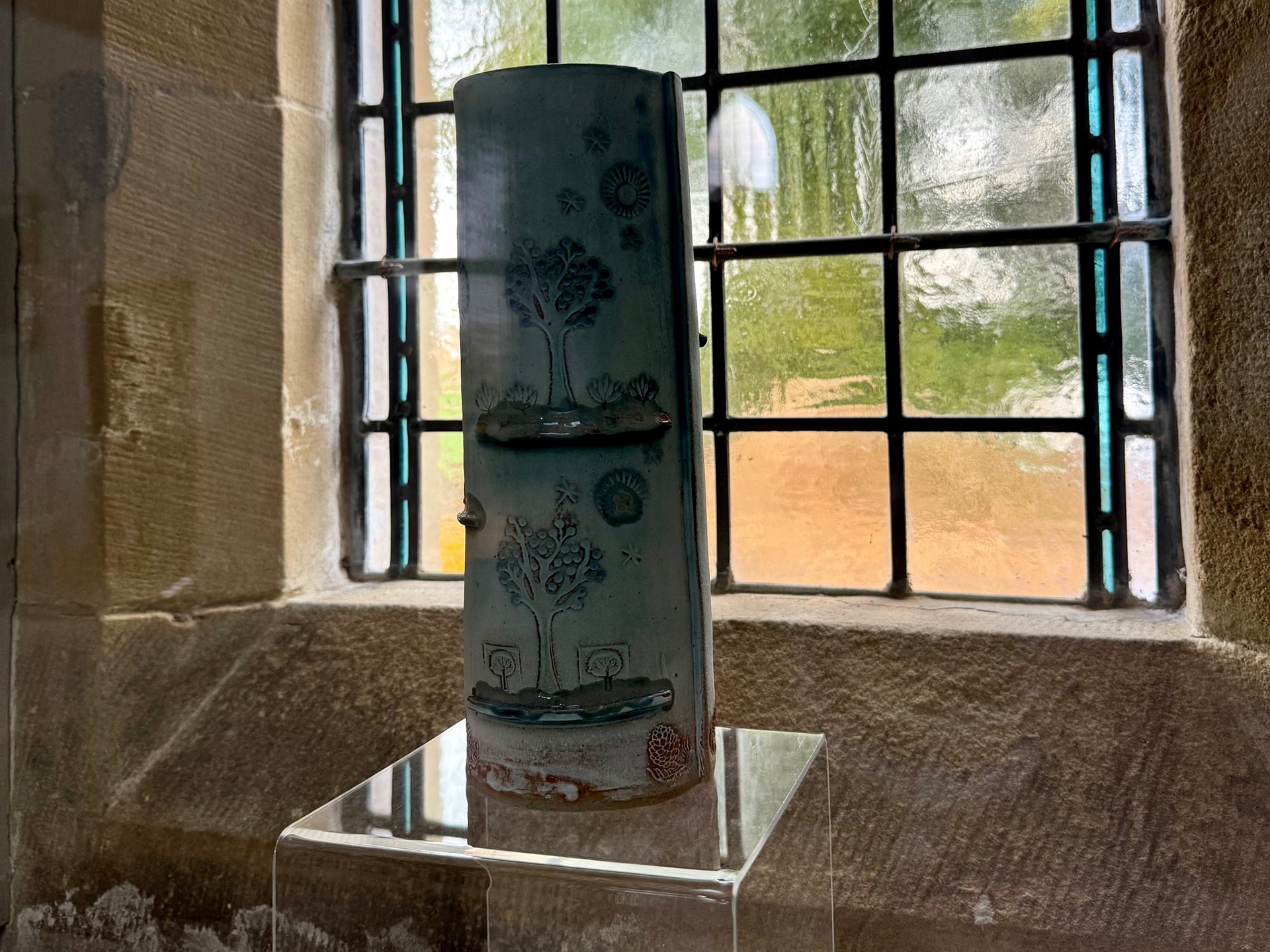A ceramic vase on a window sill